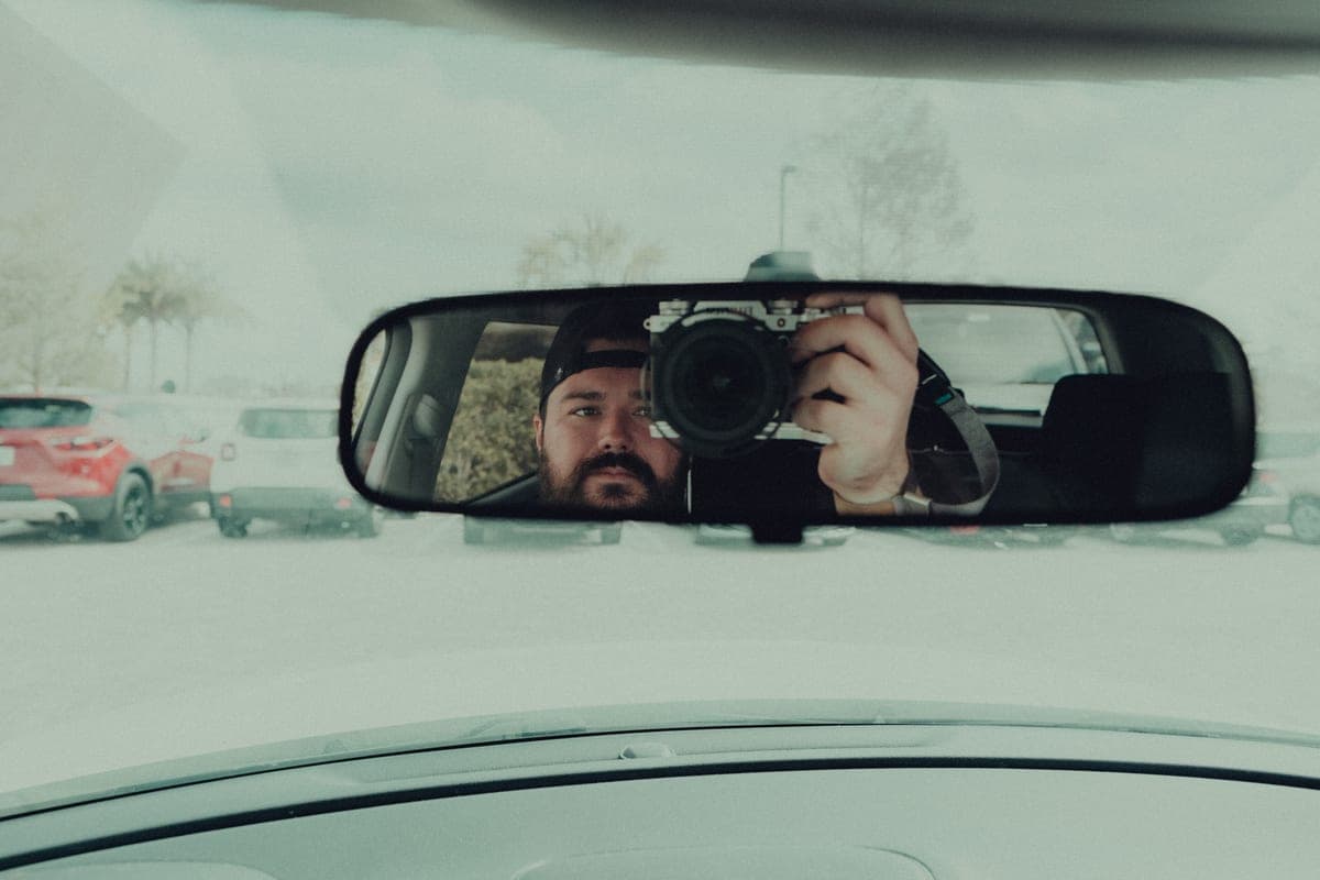 A dash camera mounted behind a car windshield